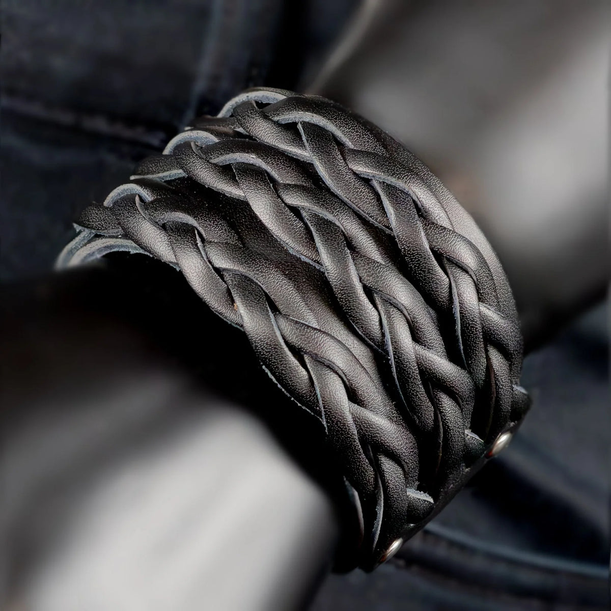 Intricately braided black leather bracelet or cuff.