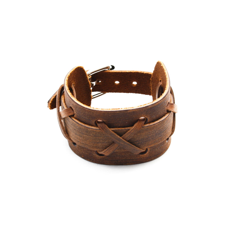 Brown leather cuff bracelet with a crisscross lacing pattern.