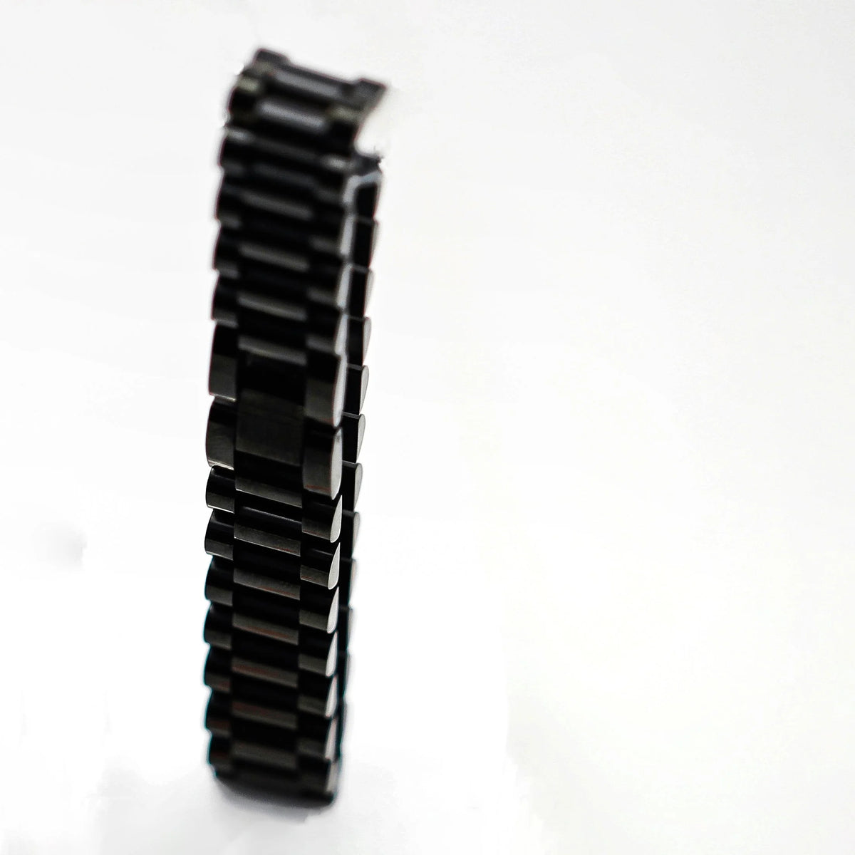 Black metal watch band or bracelet with interlocking links.