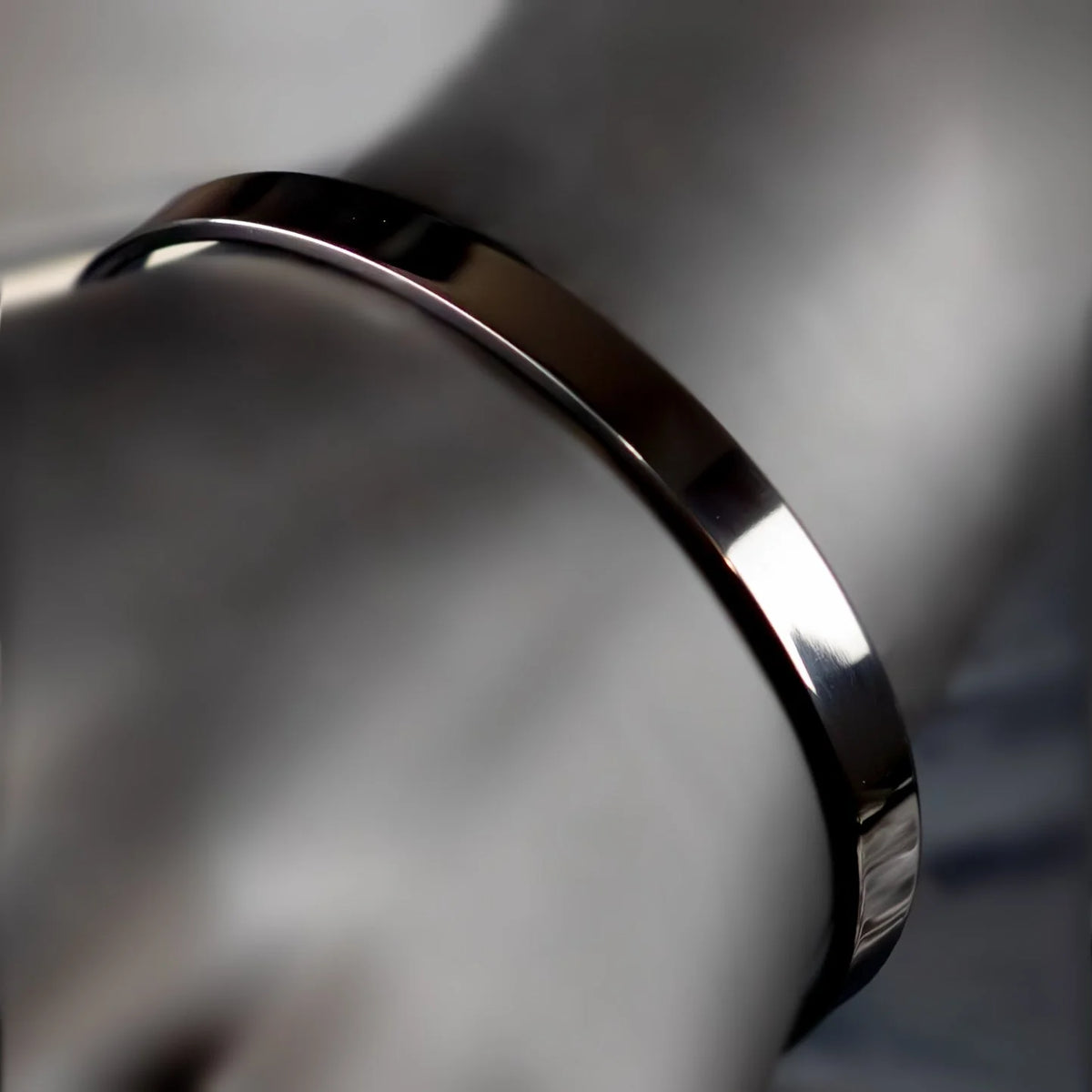 Shiny metallic ring or band with a smooth, curved surface.