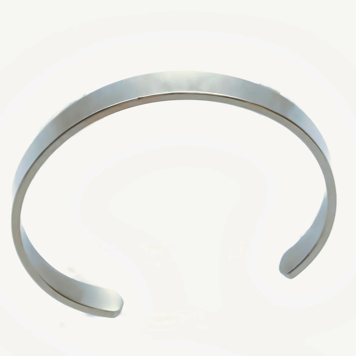 Silver metal cuff bracelet with open ends.