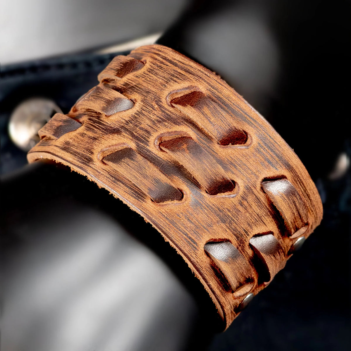 Intricately carved wooden cuff bracelet with geometric cutout patterns.