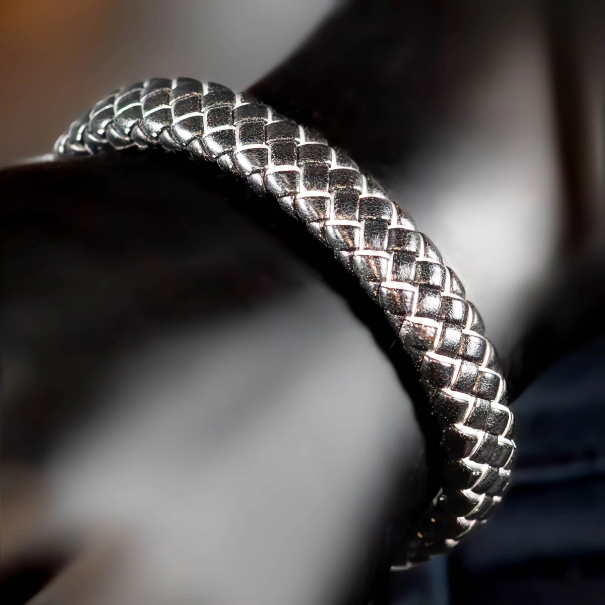 Silver braided bracelet with a woven pattern.