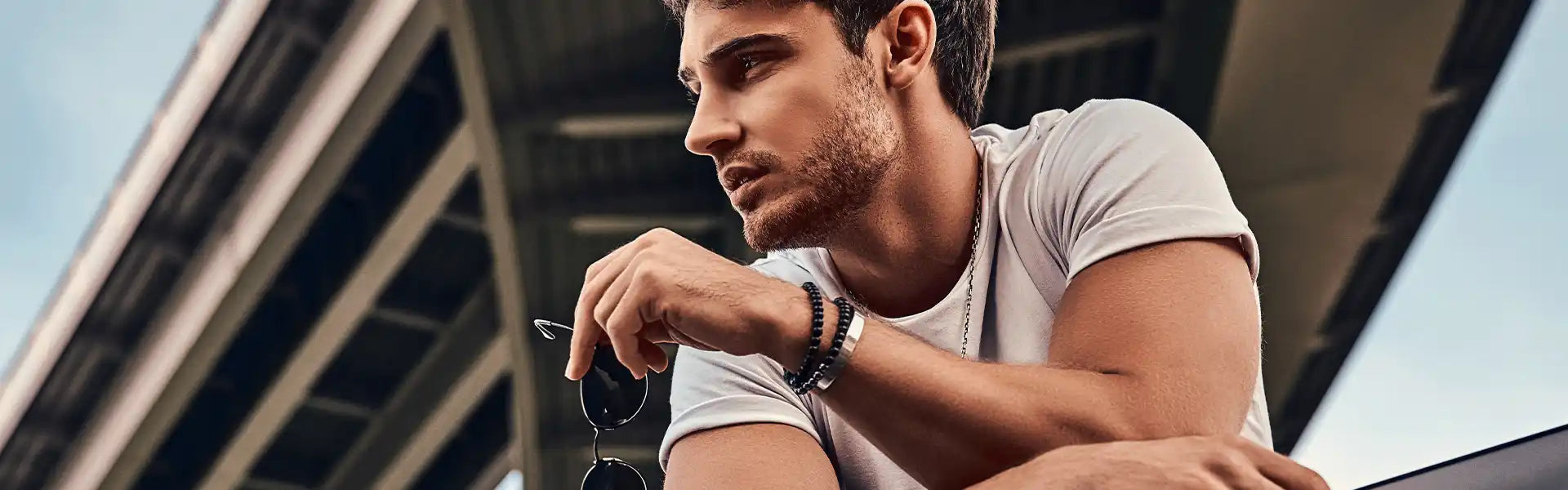 White t-shirt with fitted sleeves on a person checking their watch.