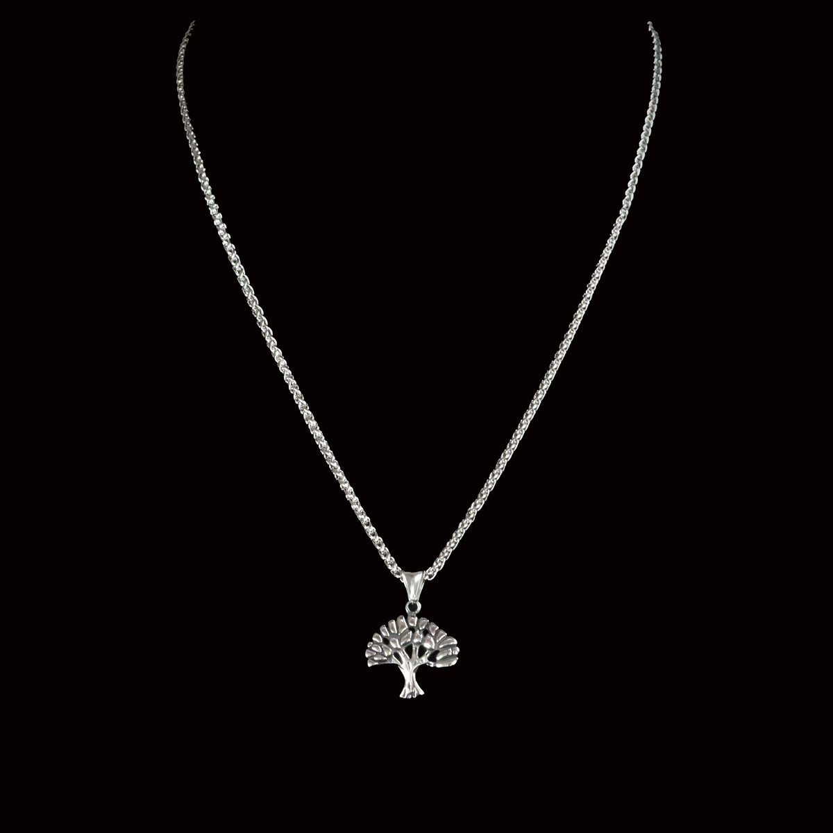 Silver necklace with a tree-shaped pendant.