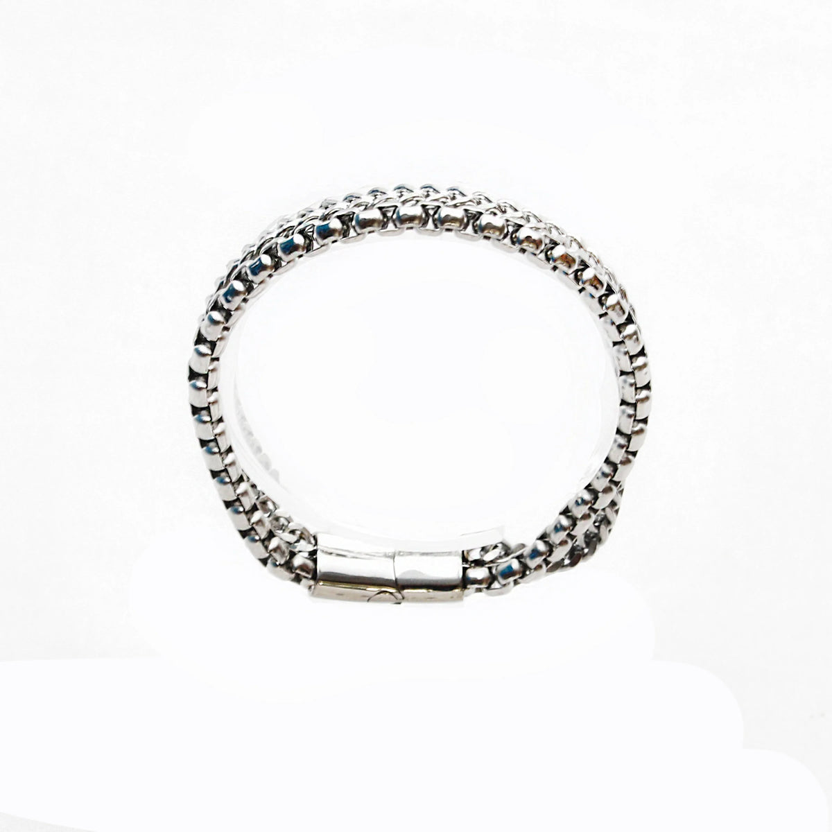 Silver chain bracelet with a textured, woven-like pattern and a clasp closure.