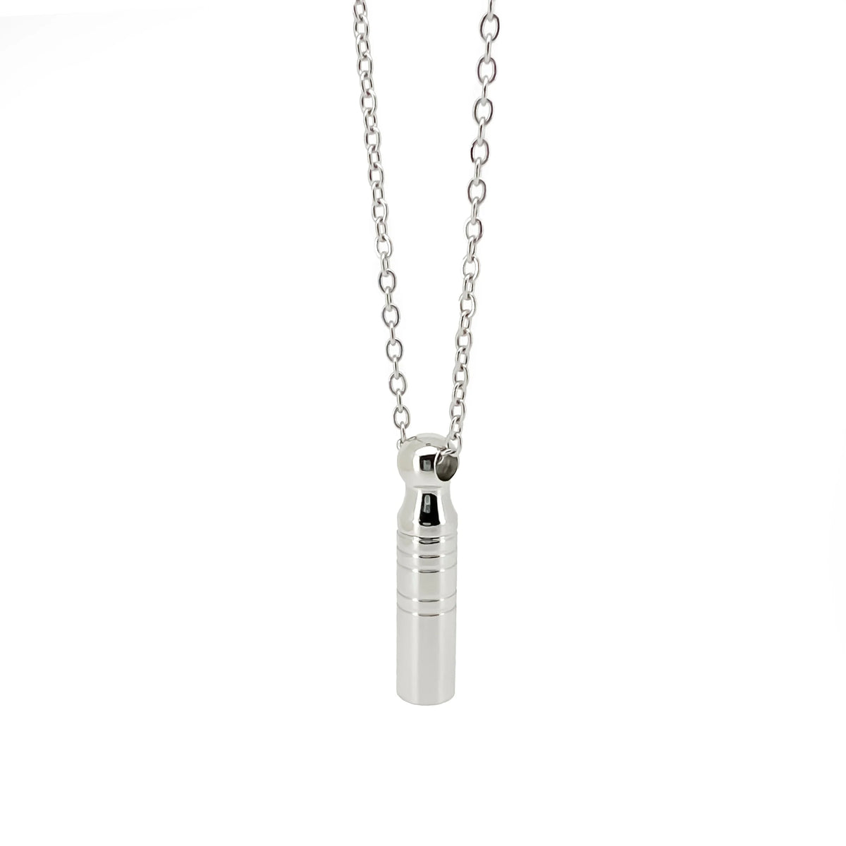 Silver cylindrical pendant on a delicate chain necklace.