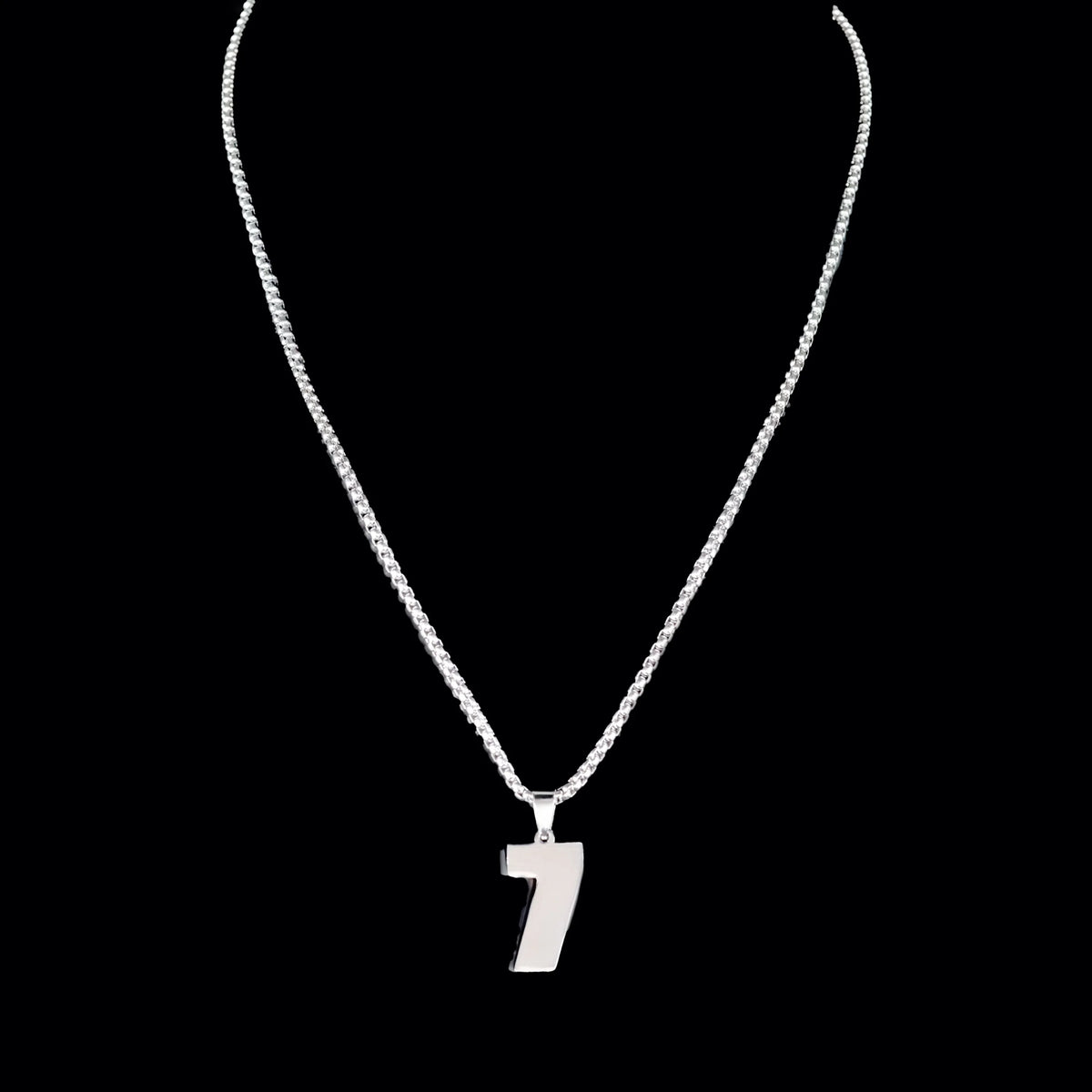 Silver necklace with a number 7 pendant.